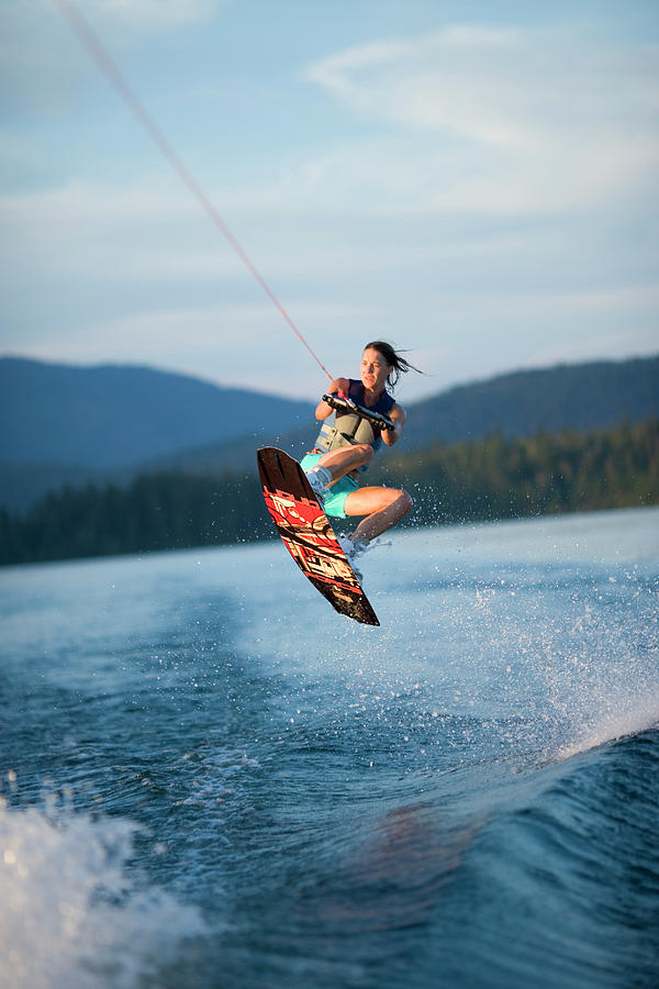 A Woman Jumps On A Wakeboard Photograph by Woods Wheatcroft - Pixels